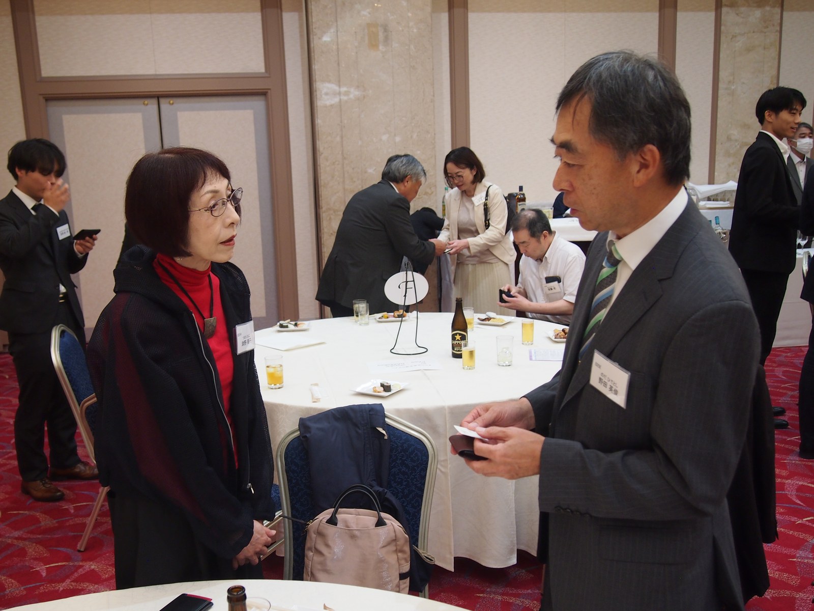 第7回交流会で名刺を手に話す参加者